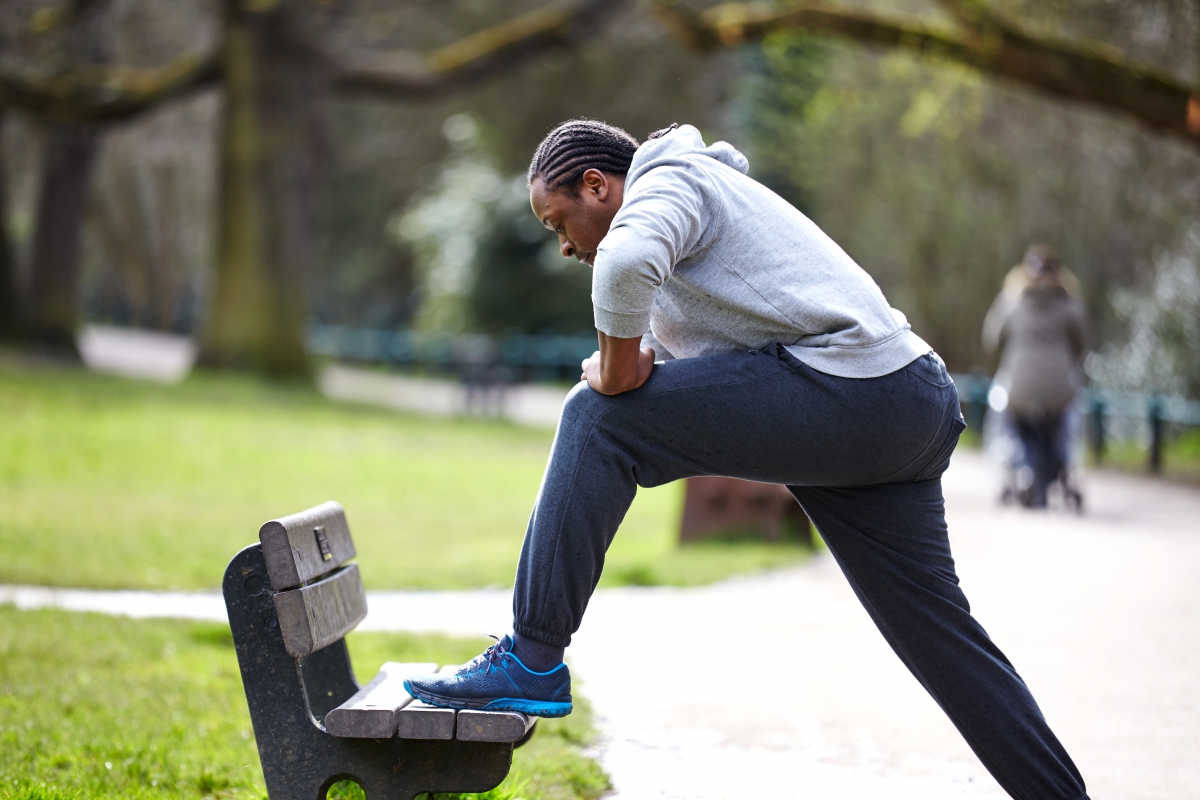 Man stretching after a run in the park