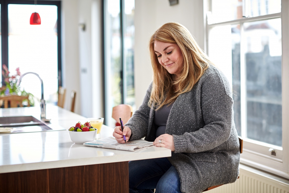 Woman writing in the kitchen 