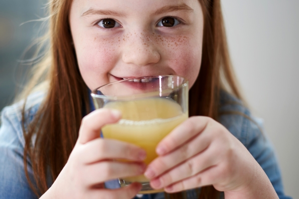 Girl drinking apple juice 