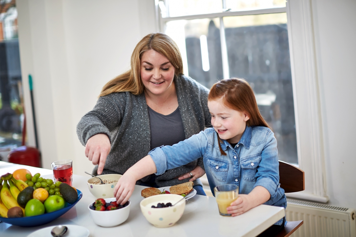 Mother preparing food for daughter 