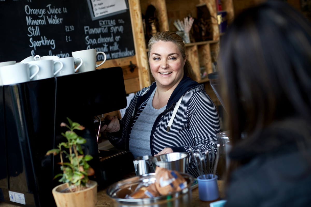 Woman in a coffee shop taking an order