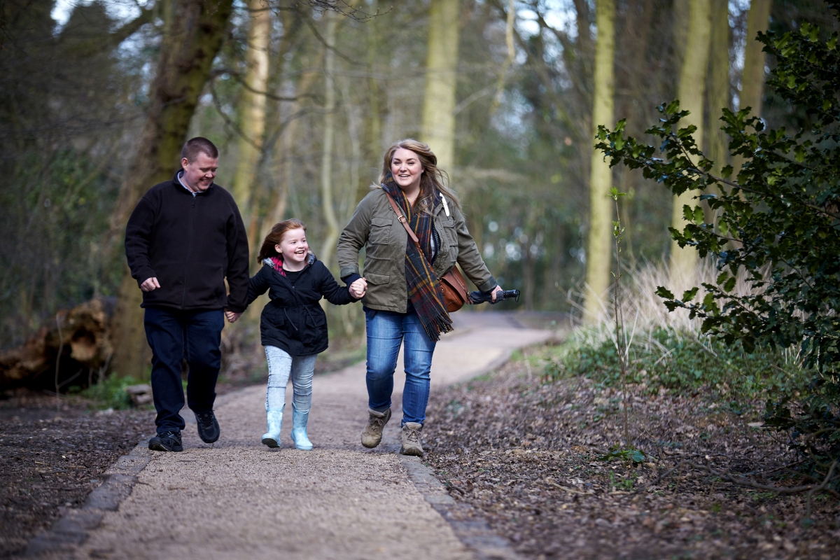 Smiling family walking in the woods 