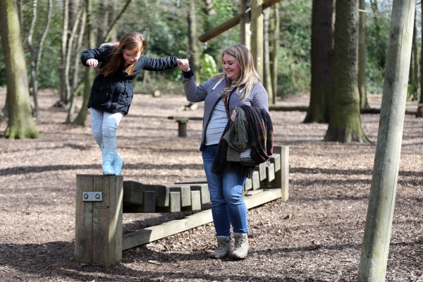 Mother & daughter in the woods playing 