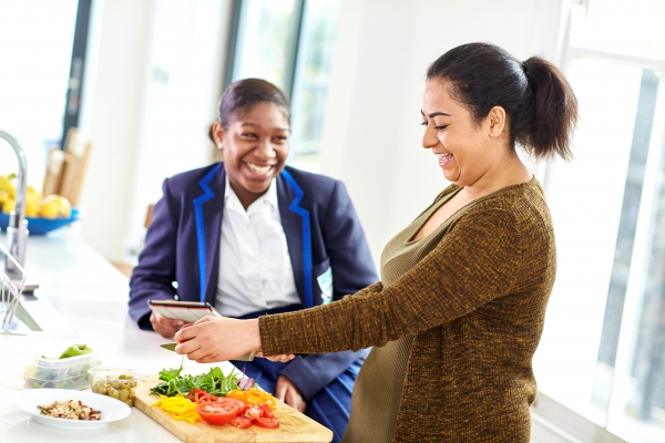 Mum making a healthy lunch for daughter 