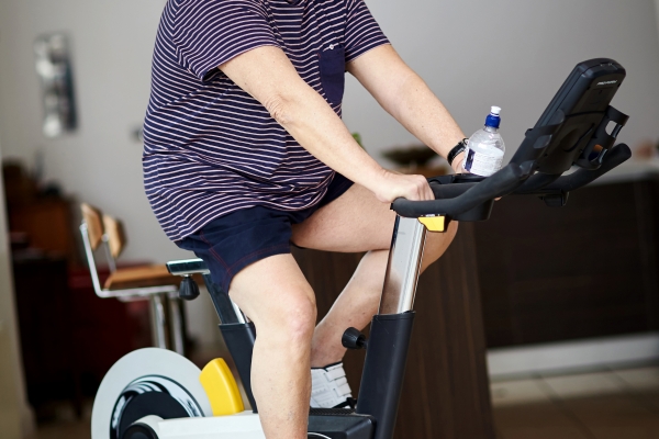 Older man working out on exercise bike