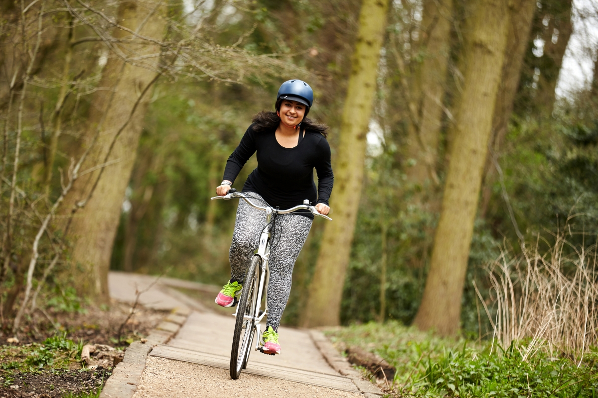 Woman riding her bike in the woods 
