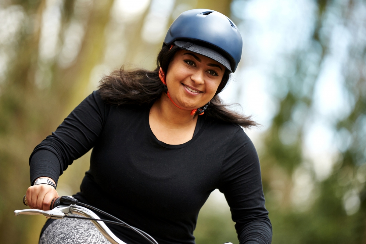 Woman on bike wearing helmet