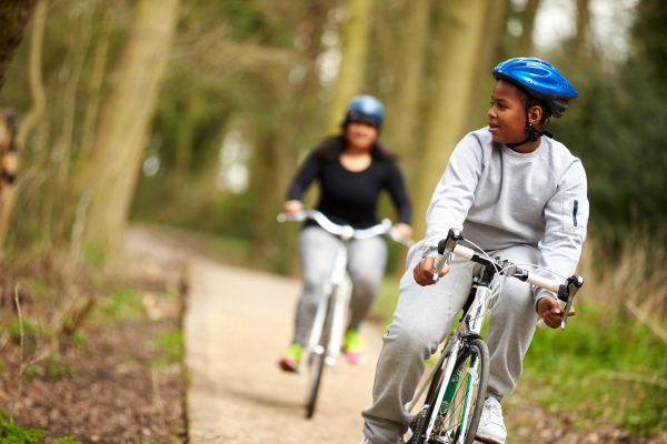 Teenage boy and Mum on bikes in the wood 