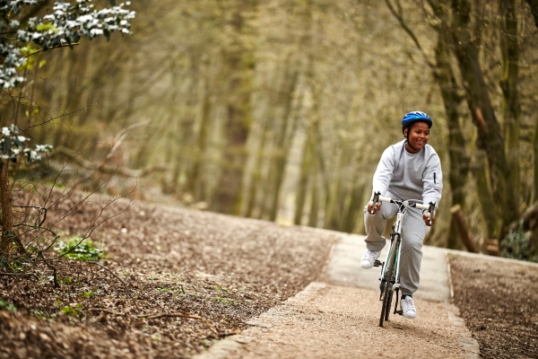 Teenage boy cycling in the woods 