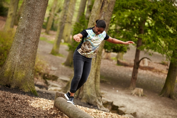 Teenage girl playing in the woods