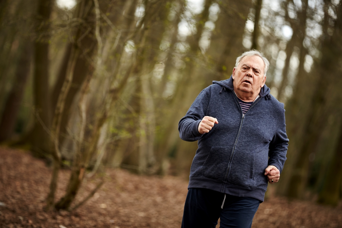 Elderly man running in wood