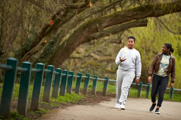 Friends walking and talking in the park 