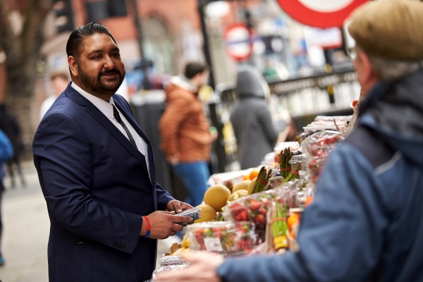 Man at food stall, browsing its wares 