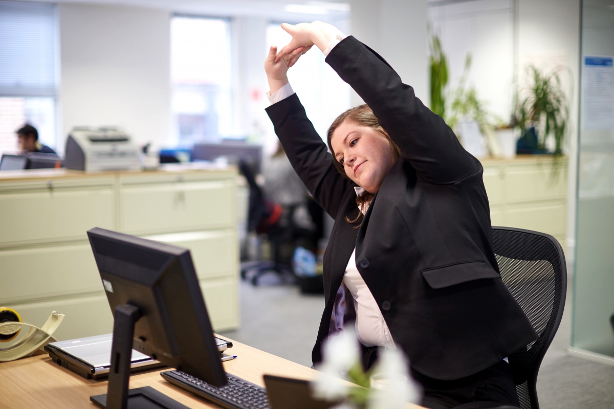 Employee stretching at desk
