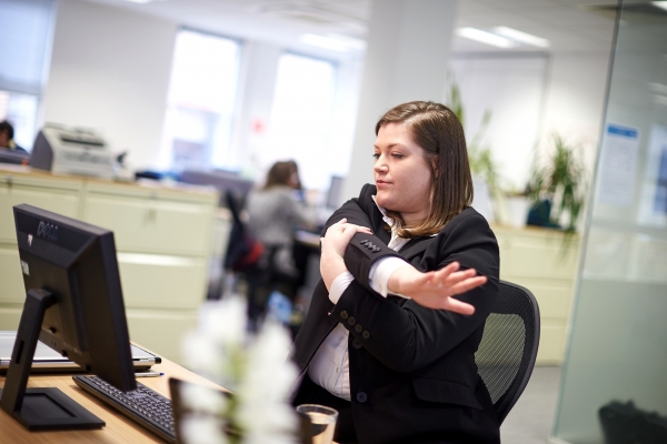 Woman stretching at desk