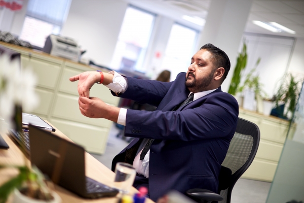 Business man talking stretching at desk