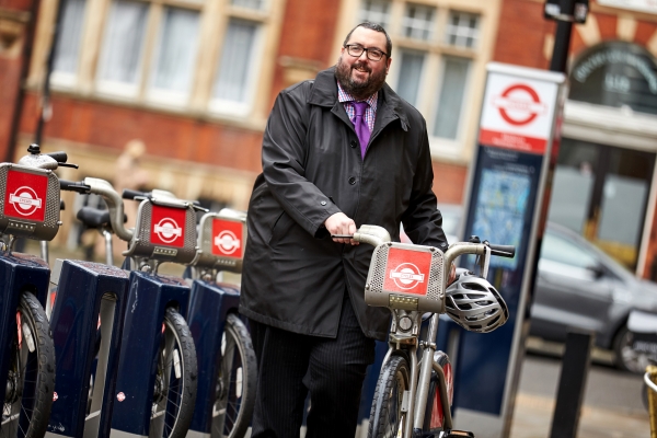 Business man parking his pedal bike 