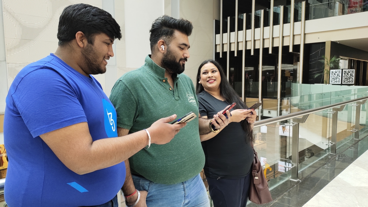 Friends on their phones at the mall