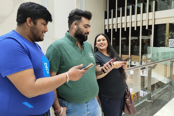 Friends on their phones at the mall