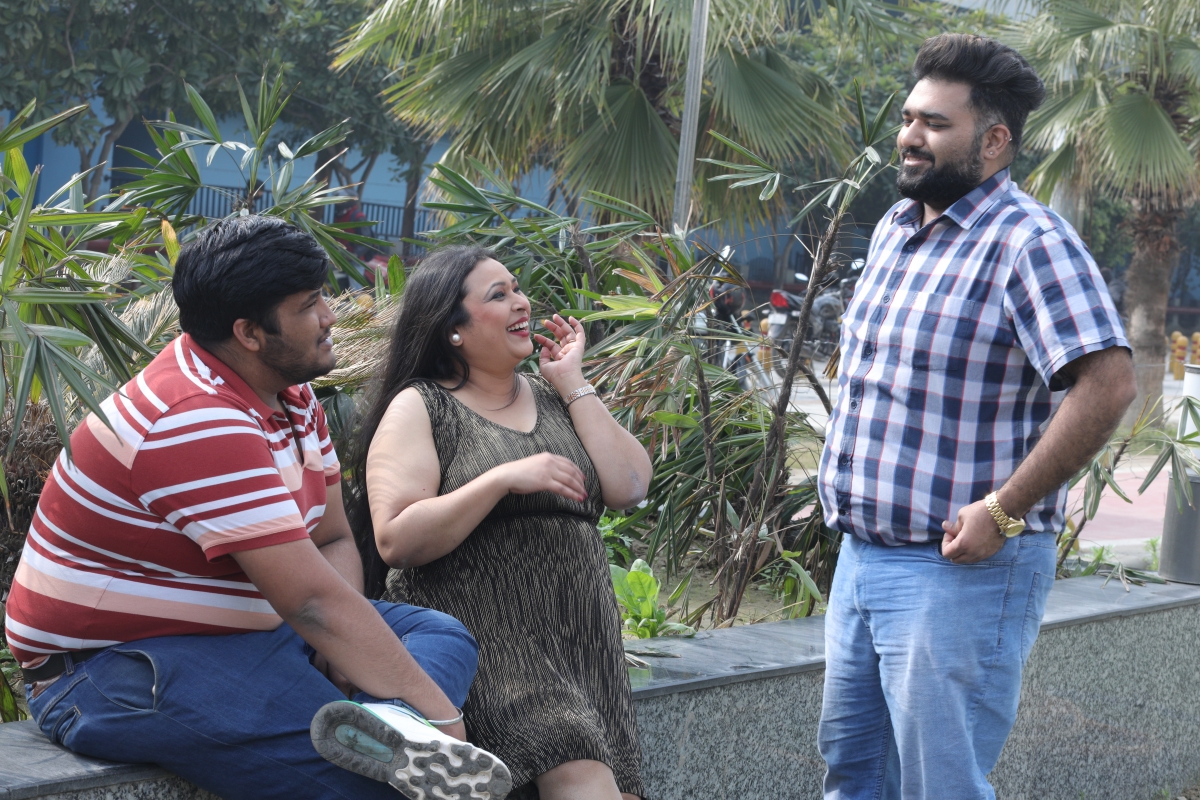 Three friends socialising outdoors