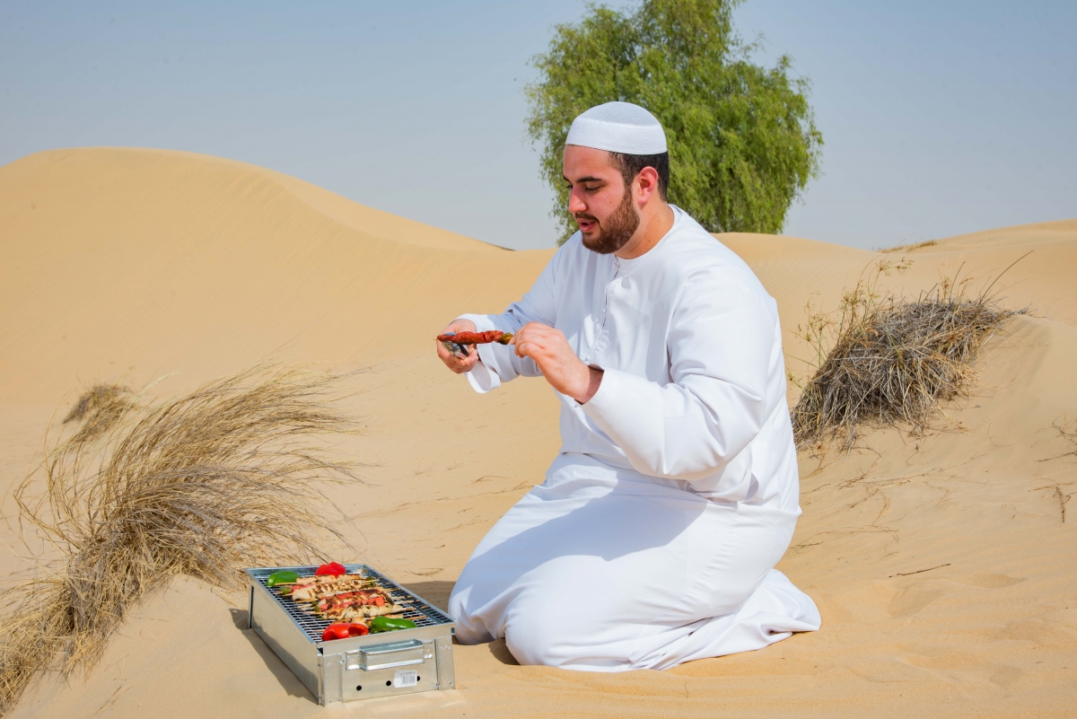 Man barbecuing two