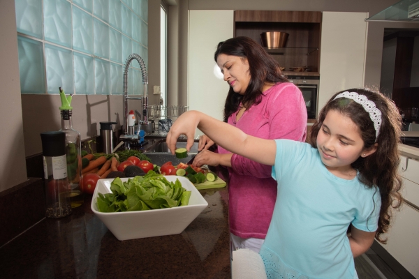 Woman and child preparing dinner