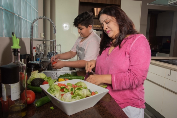 Woman and boy preparing dinner 